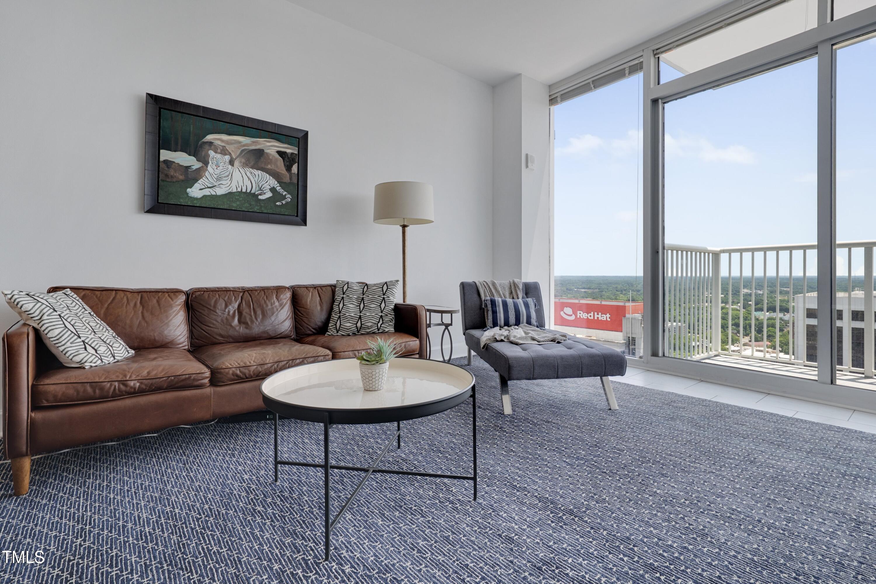 301 Fayetteville Street, Unit 2611 Raleigh, NC 27601 - Photo 5 of 44 a living room with furniture and a large window