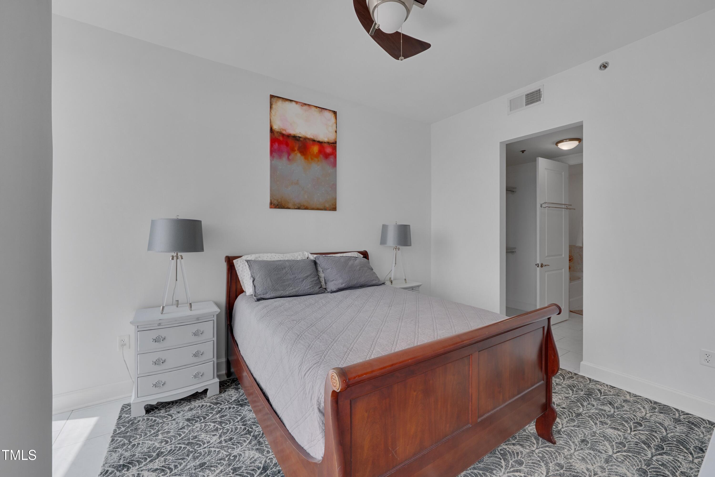 301 Fayetteville Street, Unit 2611 Raleigh, NC 27601 - Photo 7 of 44 a room with a bed and a painting on the wall