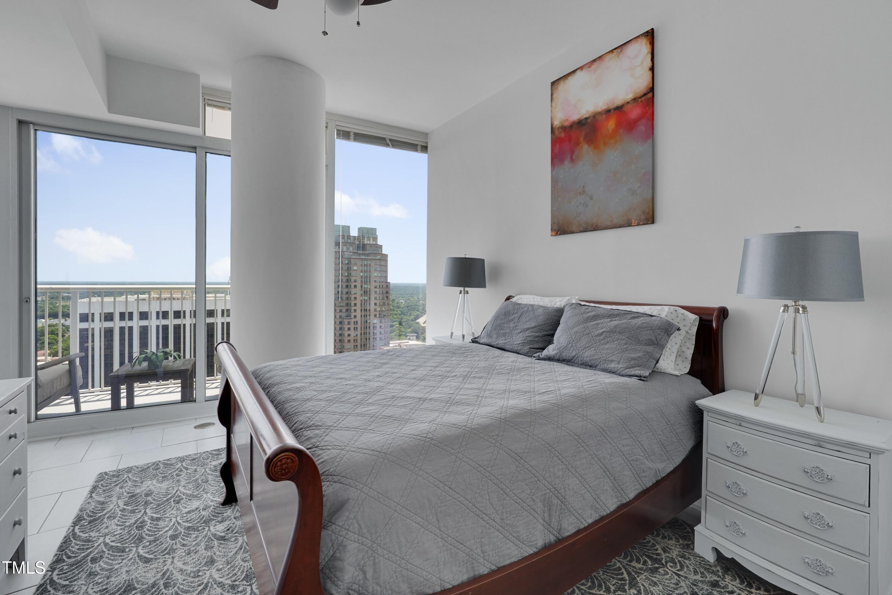 301 Fayetteville Street, Unit 2611 Raleigh, NC 27601 - Photo 8 of 44 a bed room with a bed and a table