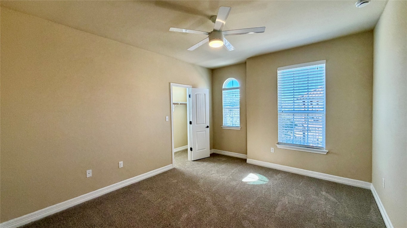12300 Terraza Circle, Unit TH10 Austin, TX 78726 - Photo 13 of 36 a view of an empty room with a window