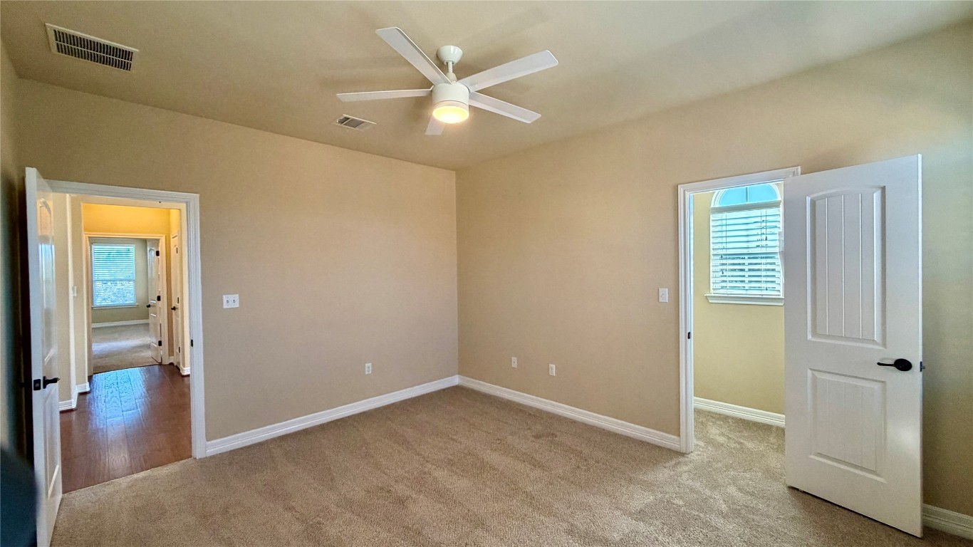 12300 Terraza Circle, Unit TH10 Austin, TX 78726 - Photo 14 of 36 an empty room with closet and a ceiling fan