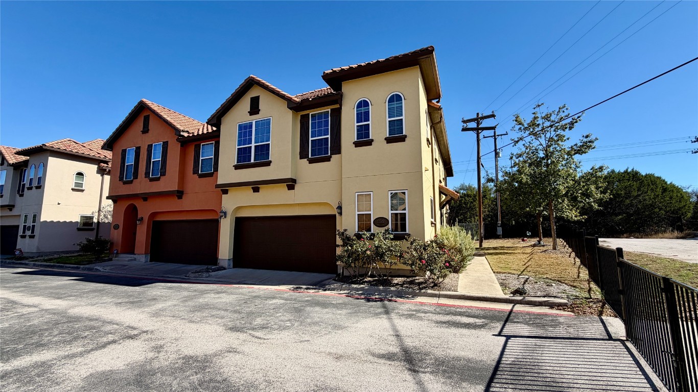 12300 Terraza Circle, Unit TH10 Austin, TX 78726 - Photo 2 of 36 a front view of a house with a yard