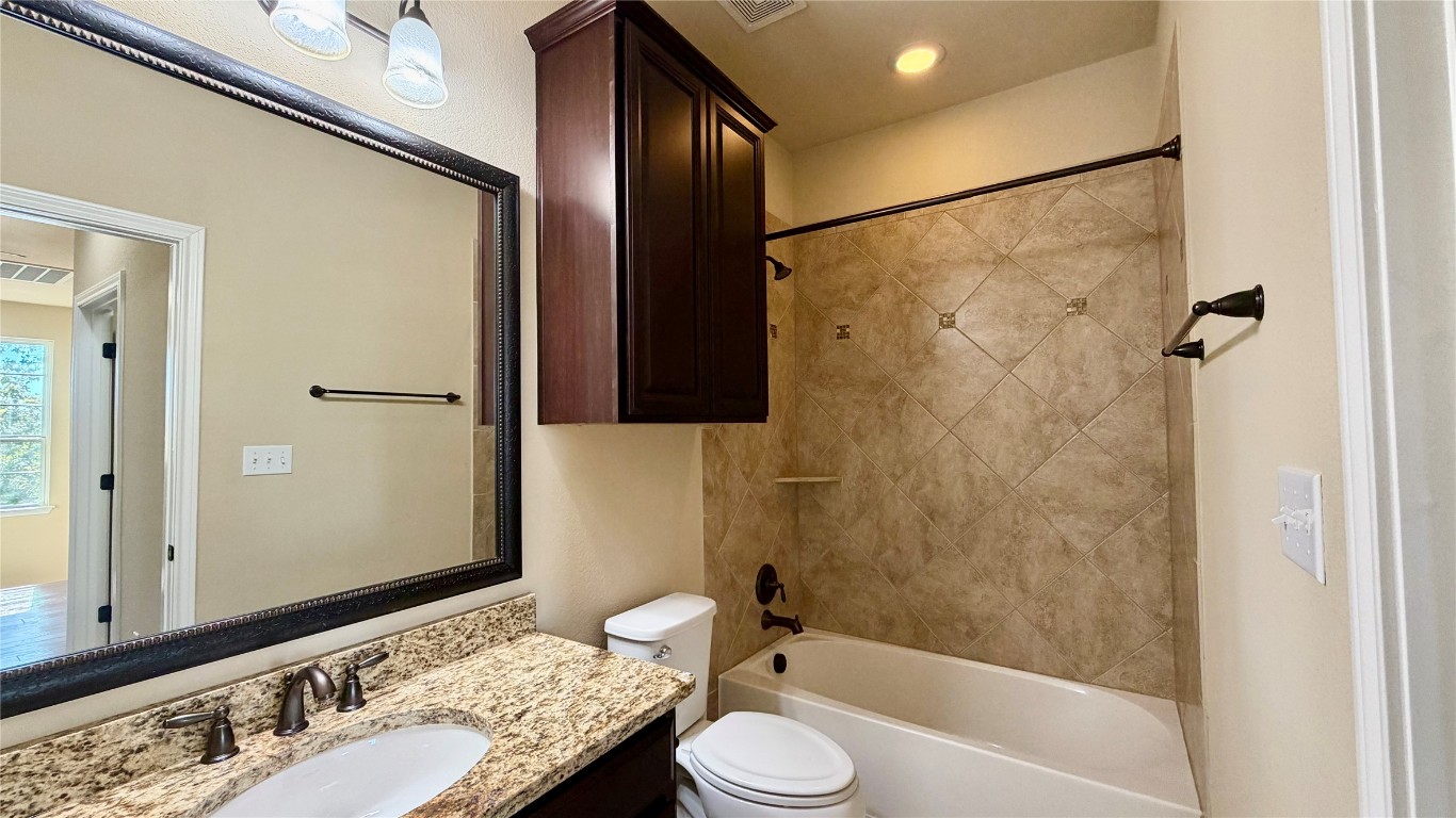 12300 Terraza Circle, Unit TH10 Austin, TX 78726 - Photo 18 of 36 a bathroom with a granite countertop sink toilet and shower