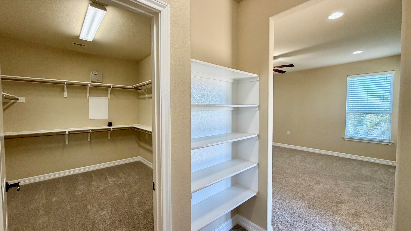 12300 Terraza Circle, Unit TH10 Austin, TX 78726 - Photo 20 of 36 a view of walk in closet with empty racks