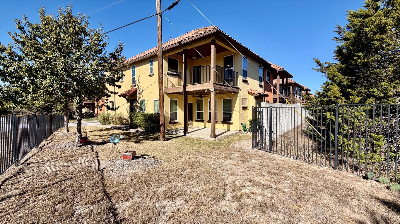 12300 Terraza Circle, Unit TH10 Austin, TX 78726 - Photo 24 of 36 a view of a large white house with a small yard and large trees