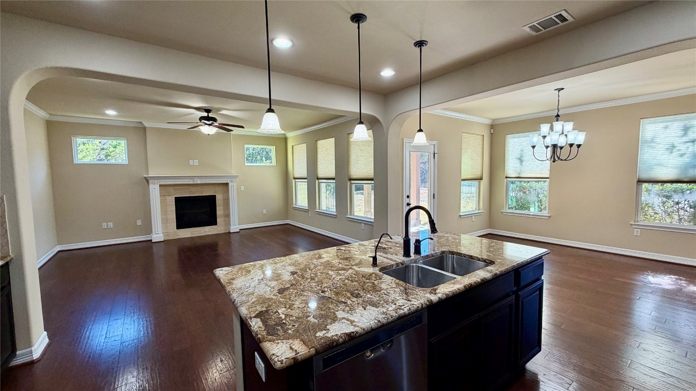 12300 Terraza Circle, Unit TH10 Austin, TX 78726 - Photo 34 of 36 a kitchen with granite countertop a sink cabinets and wooden floor