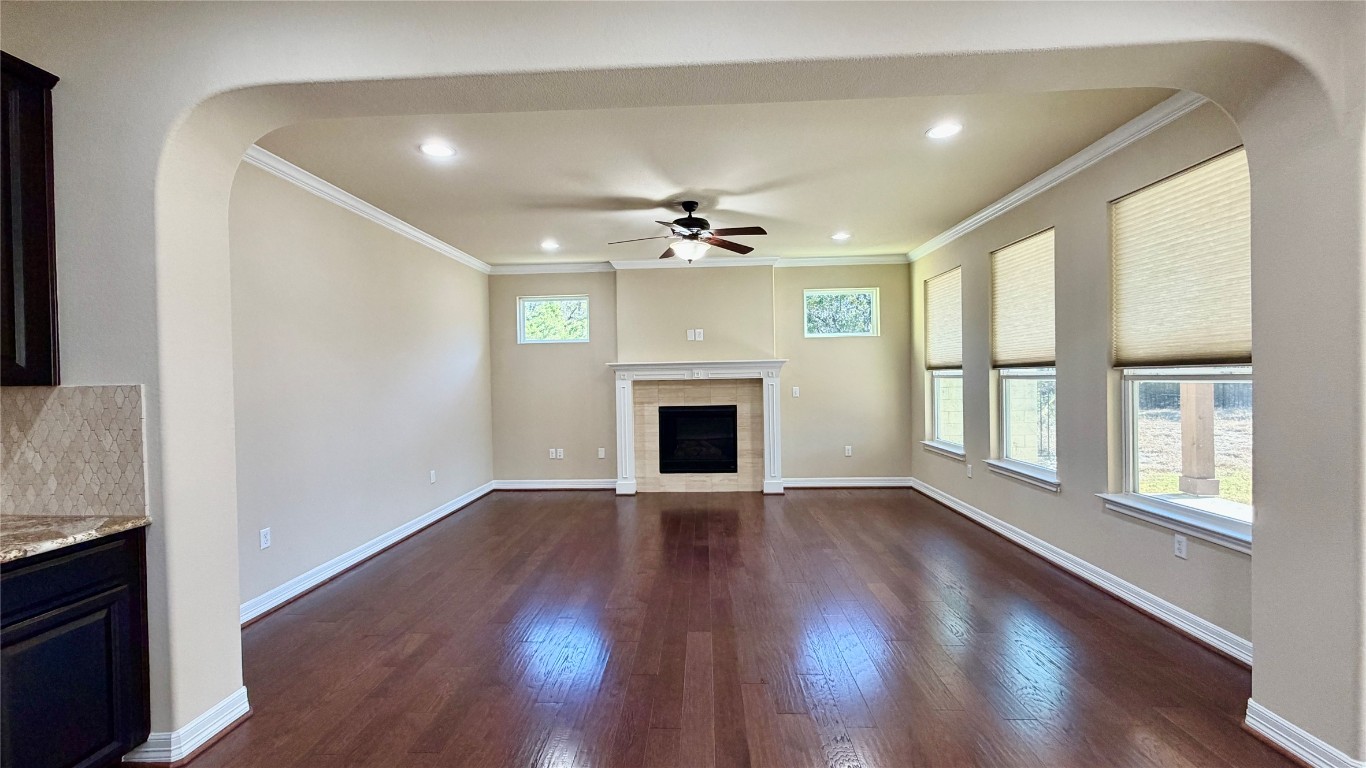 12300 Terraza Circle, Unit TH10 Austin, TX 78726 - Photo 7 of 36 an empty room with wooden floor fireplace and windows