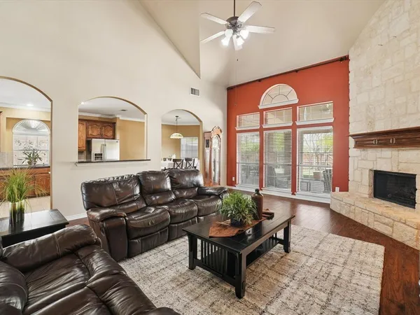 a living room with furniture fireplace and a large window