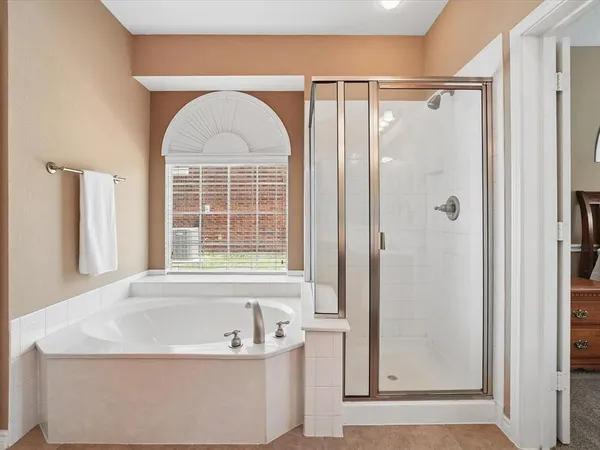 a bathroom with a bathtub and a shower