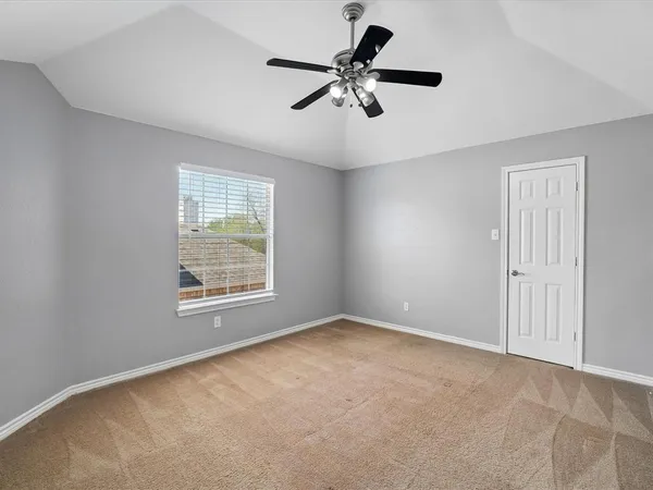 a view of room with a ceiling fan and window