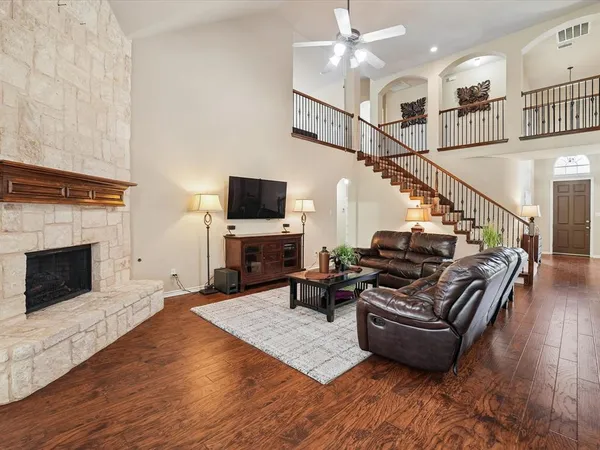 a living room with furniture fireplace and flat screen tv