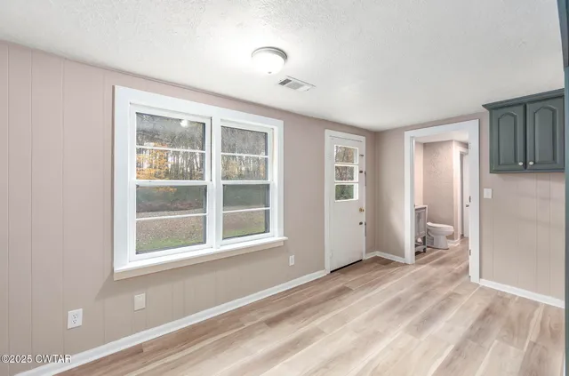 a view of an empty room with a window