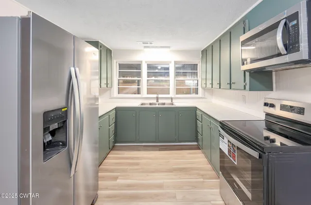 a kitchen with a sink stove and refrigerator