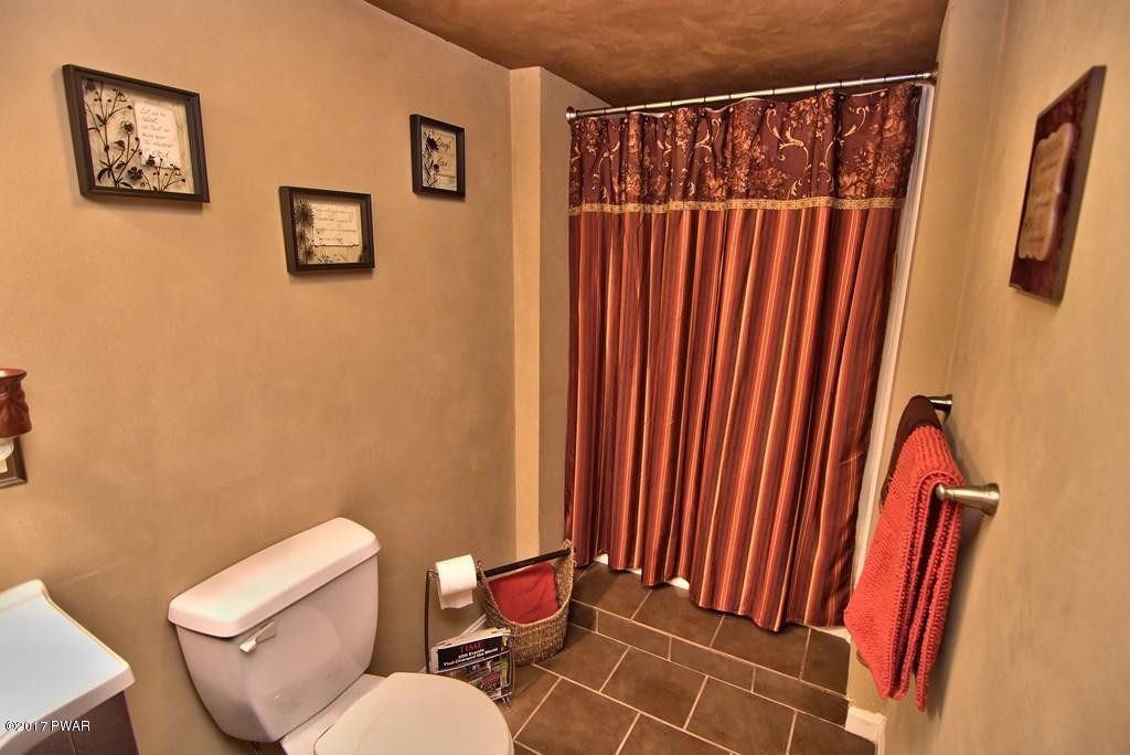 1058 Rosengrant Road Lake Ariel, PA 18436 - Photo 23 of 47 a bathroom with a toilet and a mirror