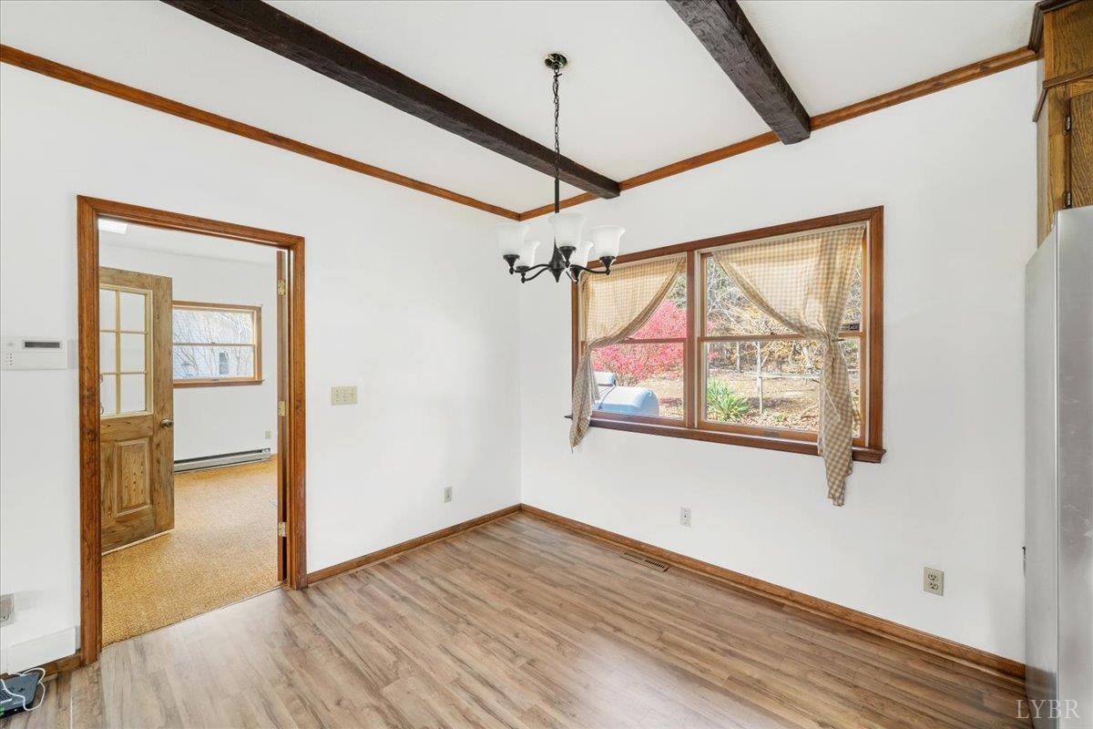 391 Pond Road Buckingham, VA 23921 - Photo 14 of 75 a view of empty room with wooden floor and fan