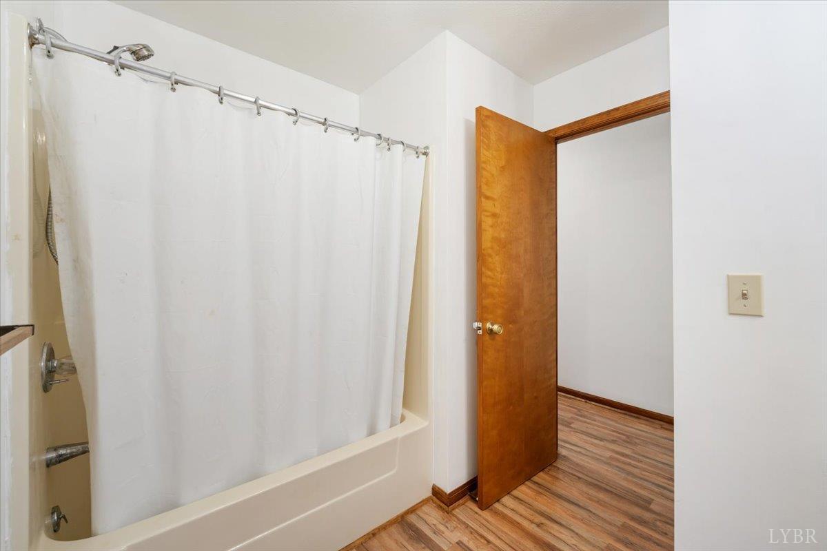 391 Pond Road Buckingham, VA 23921 - Photo 23 of 75 a view of a bathroom with a shower curtain