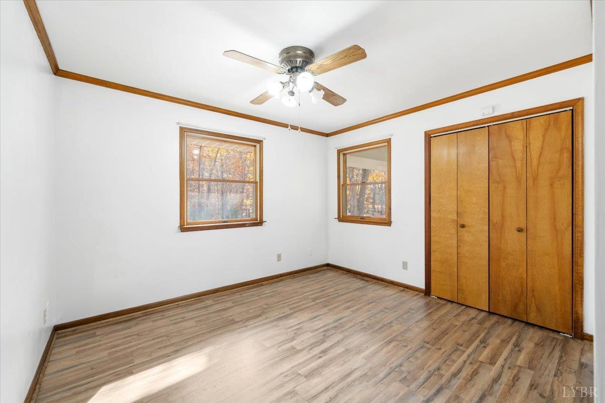 391 Pond Road Buckingham, VA 23921 - Photo 24 of 75 a view of an empty room with wooden floor and a window