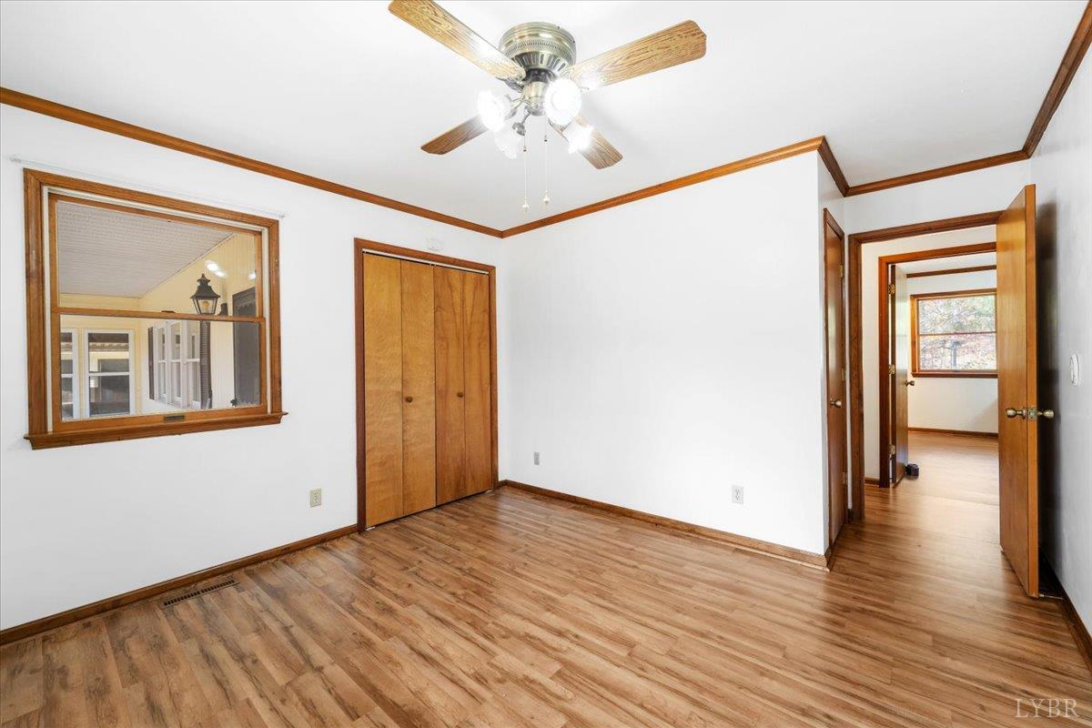 391 Pond Road Buckingham, VA 23921 - Photo 25 of 75 a view of a hallway with wooden floor and a chandelier
