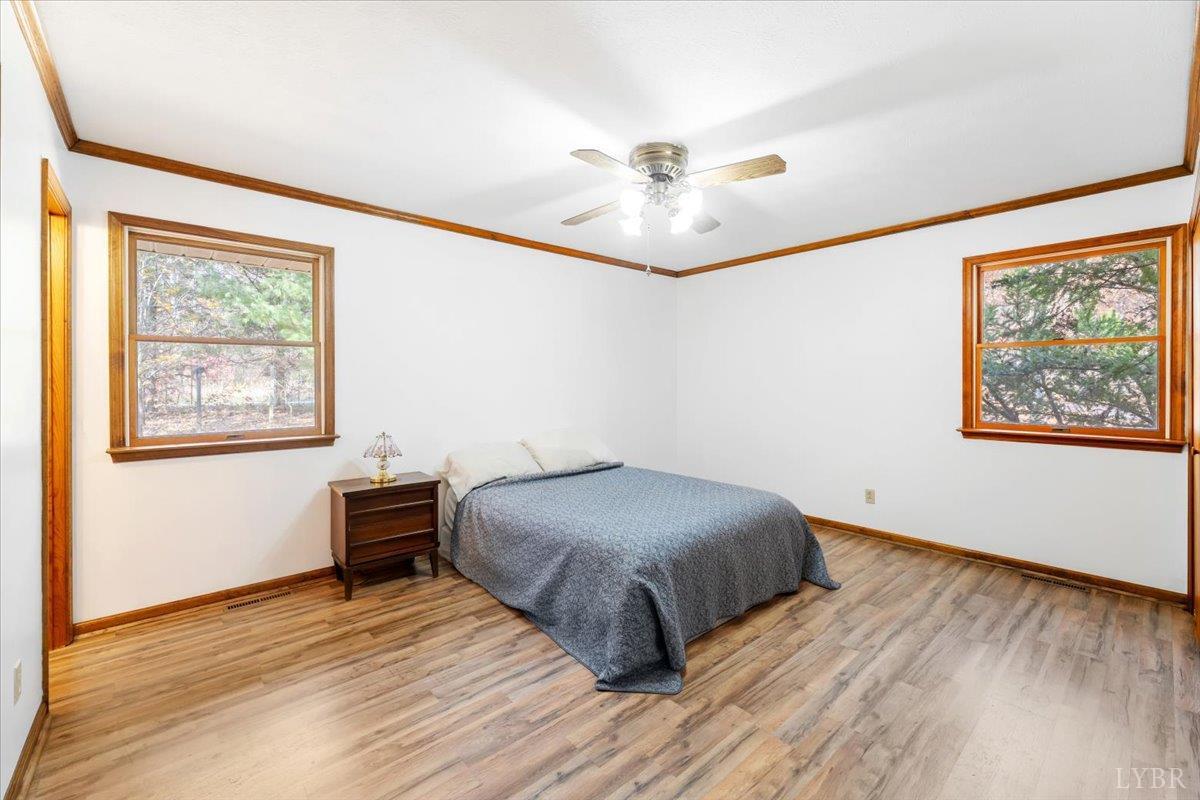 391 Pond Road Buckingham, VA 23921 - Photo 28 of 75 a bedroom with a bed and a chandelier