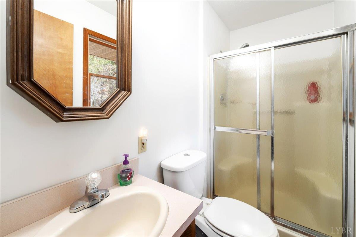 391 Pond Road Buckingham, VA 23921 - Photo 30 of 75 a bathroom with a sink toilet and shower