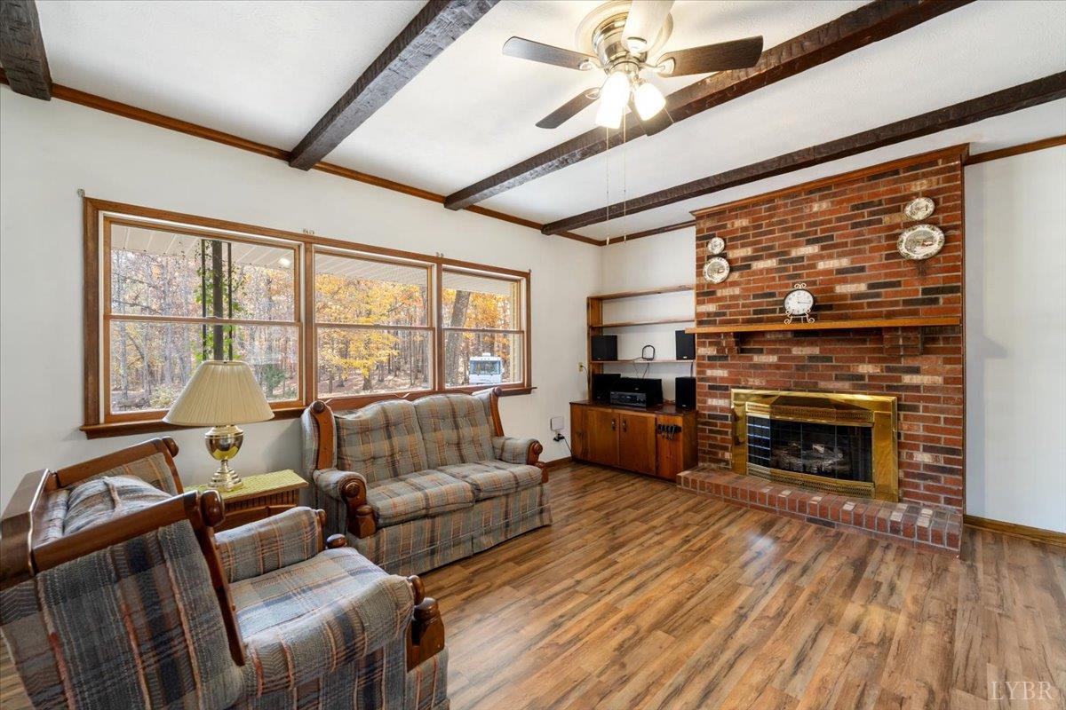 391 Pond Road Buckingham, VA 23921 - Photo 8 of 75 a living room with furniture a fireplace and a floor to ceiling window