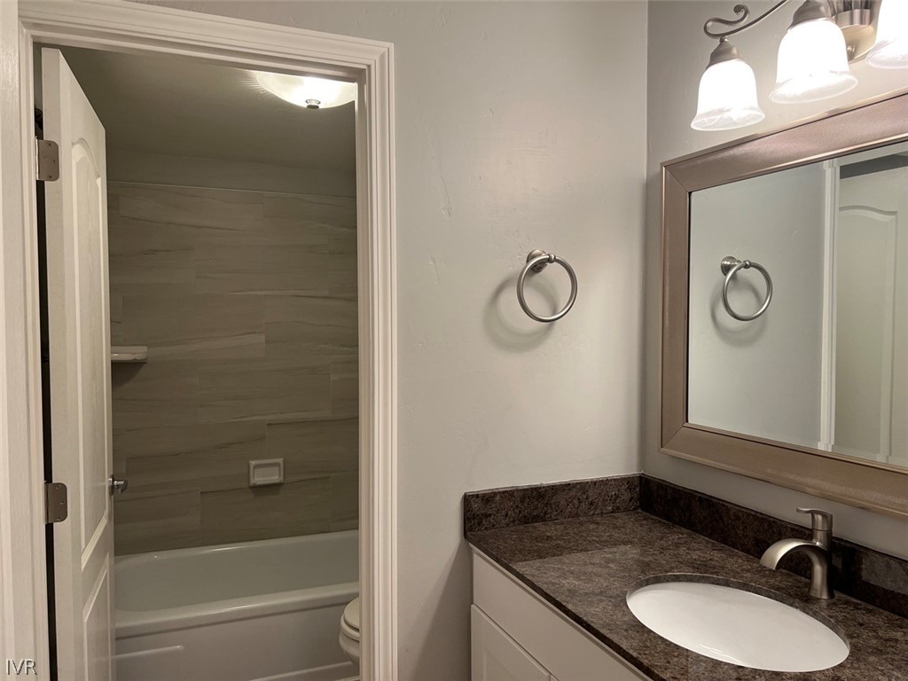 115 Tramway Drive, Unit 2 Stateline, NV 89449 - Photo 13 of 18 a bathroom with a granite countertop sink toilet and shower