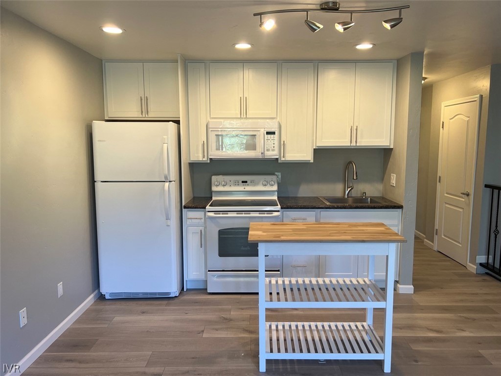 115 Tramway Drive, Unit 2 Stateline, NV 89449 - Photo 5 of 18 a kitchen with kitchen island wooden cabinets a refrigerator and a stove