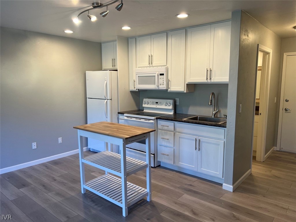 115 Tramway Drive, Unit 2 Stateline, NV 89449 - Photo 6 of 18 a kitchen with refrigerator cabinets and wooden floor