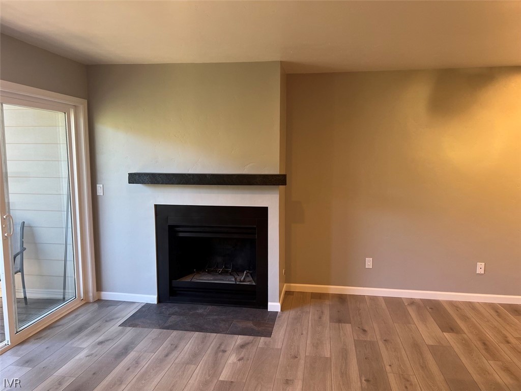 115 Tramway Drive, Unit 2 Stateline, NV 89449 - Photo 7 of 18 a view of an empty room with wooden floor and a fireplace
