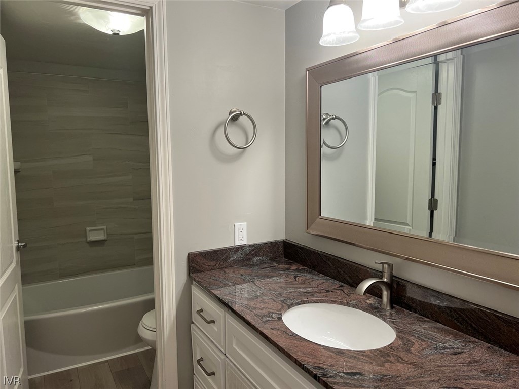 115 Tramway Drive, Unit 2 Stateline, NV 89449 - Photo 9 of 18 a bathroom with a granite countertop sink and a mirror