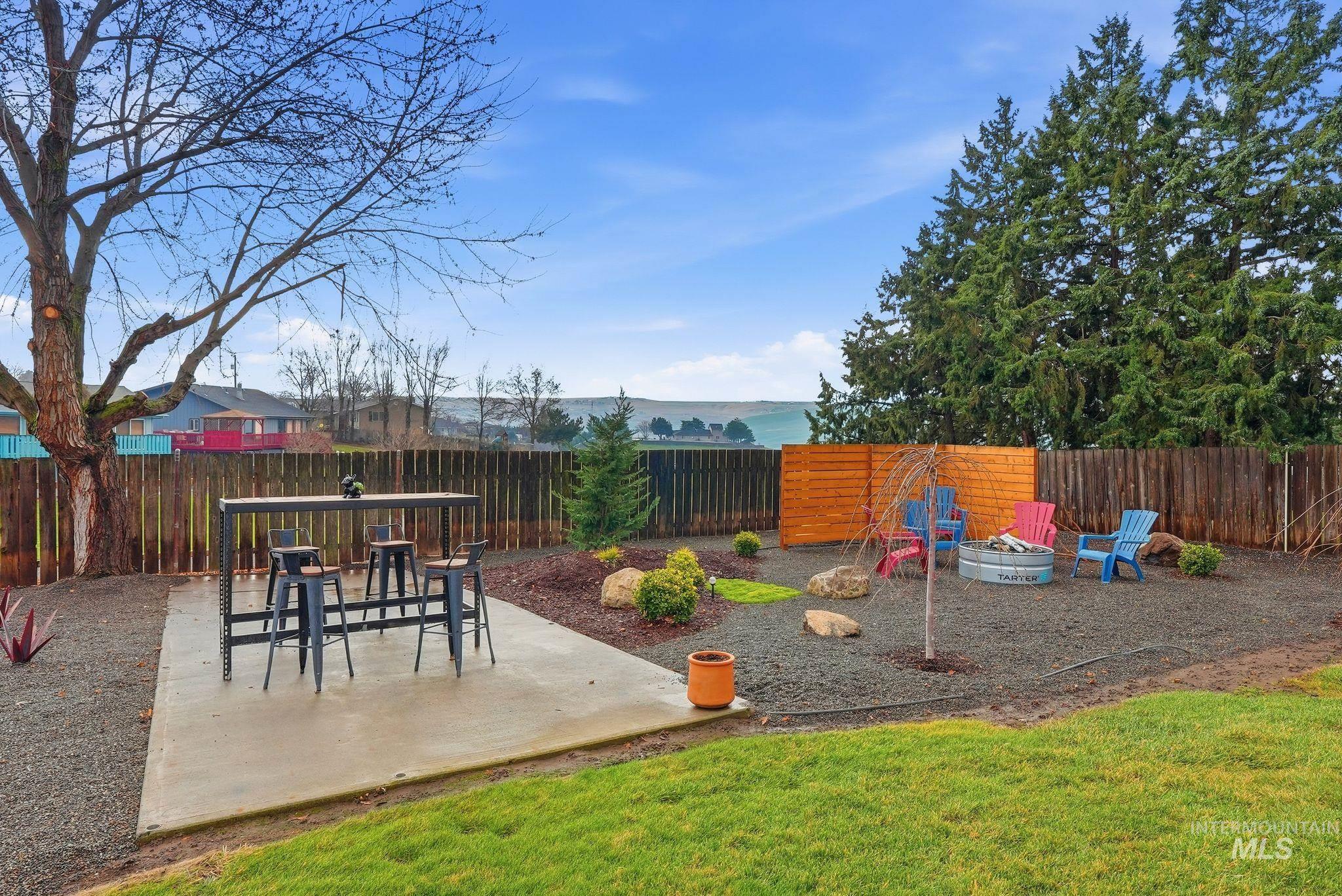 2435 Easy Street Clarkston, WA 99403 - Photo 40 of 49 Fenced backyard with a patio and an outdoor fire pit
