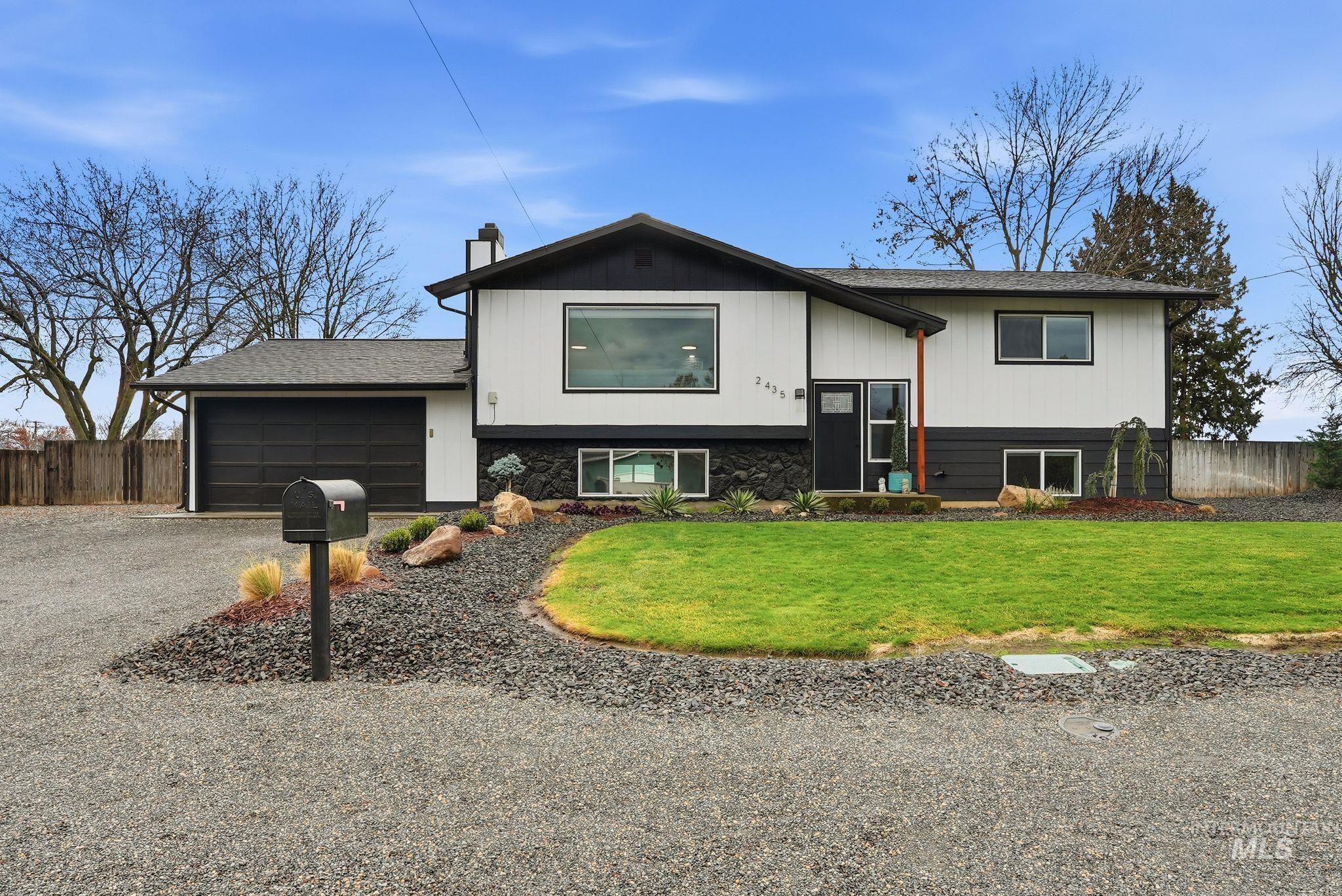 2435 Easy Street Clarkston, WA 99403 - Photo 5 of 49 Raised ranch with driveway, a chimney, an attached garage, and roof with shingles