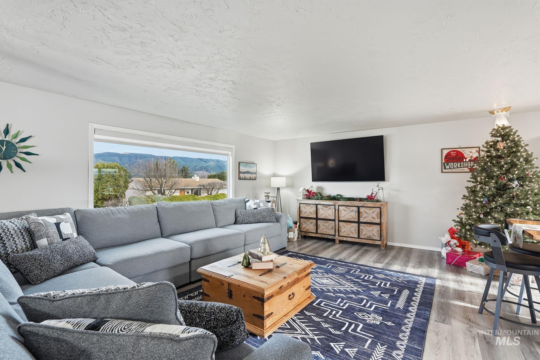 2435 Easy Street Clarkston, WA 99403 - Photo 9 of 49 Living room featuring wood finished floors and a textured ceiling