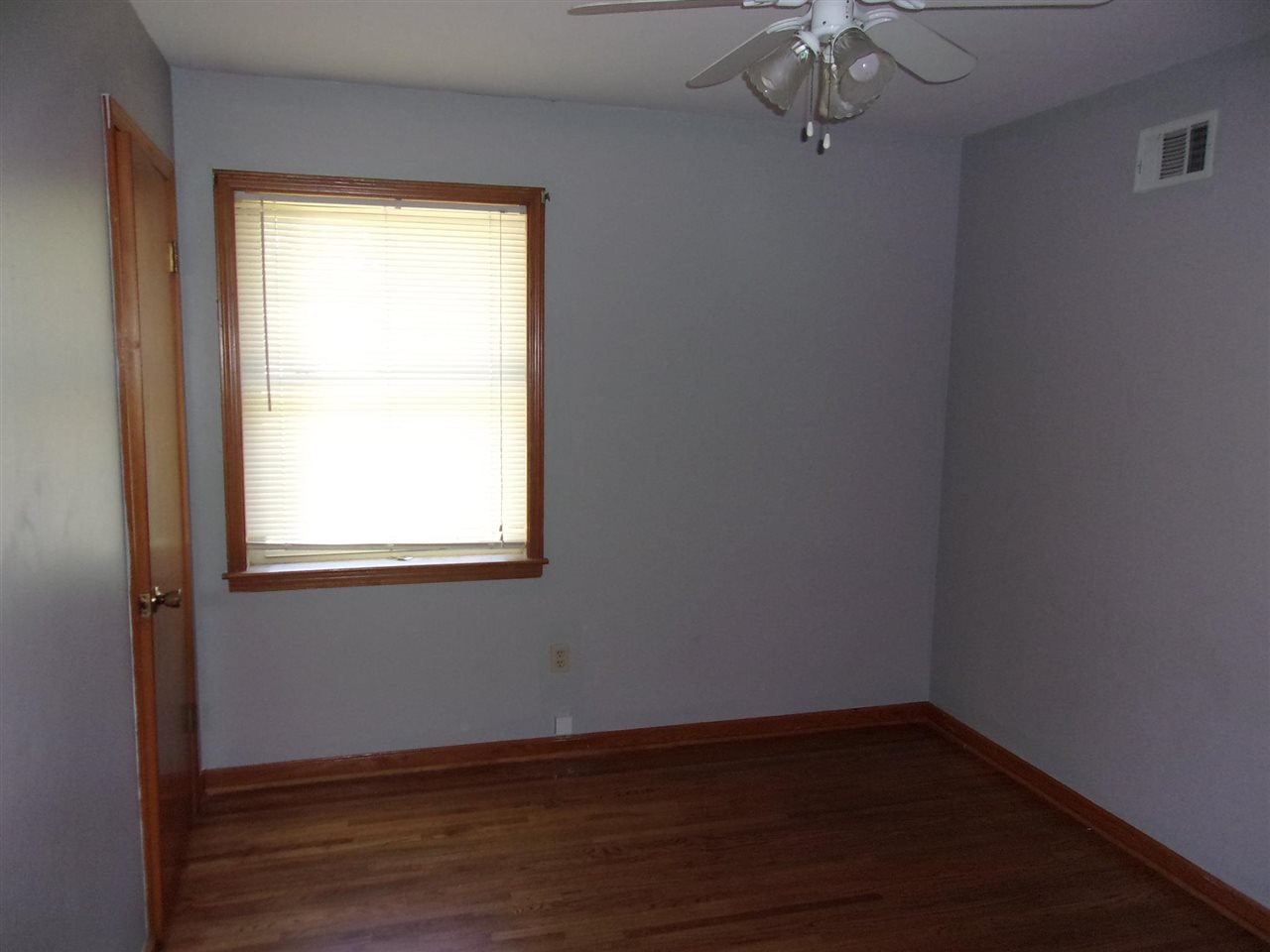 4440 Yale Road Memphis, TN 38128 - Photo 12 of 24 an empty room with wooden floor and windows