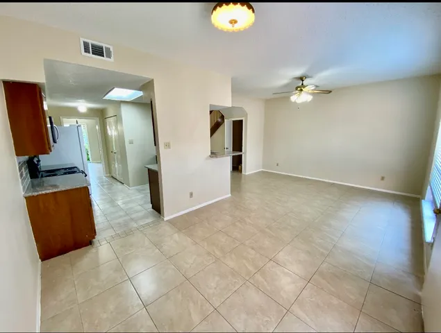an empty room with wooden floor and mirror