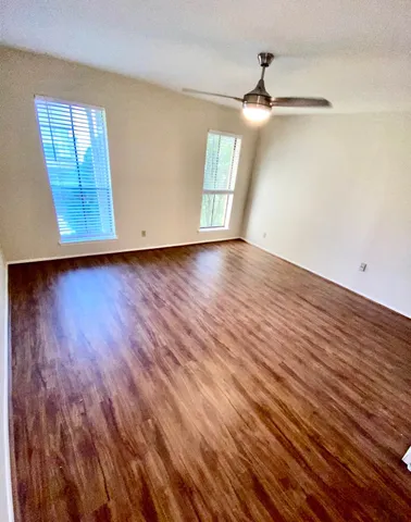 wooden floor in an empty room with a window