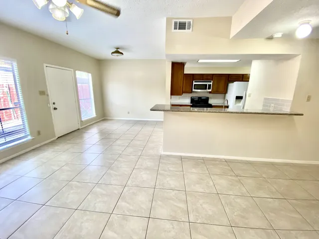 a view of a kitchen with kitchen furniture and a window