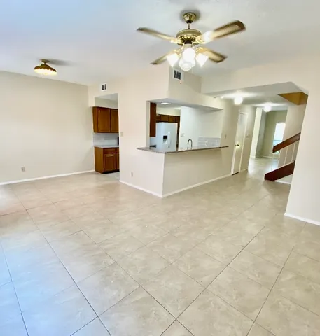 a view of kitchen with furniture and a ceiling fan
