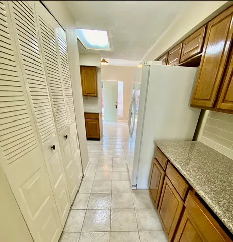 a bathroom with a granite countertop shower and a sink