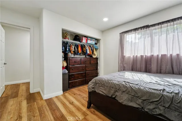 a bedroom with a bed and a closet