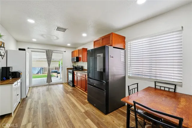 a kitchen with stainless steel appliances a refrigerator and a stove top oven