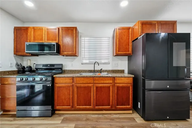 a kitchen with stainless steel appliances granite countertop a stove and a refrigerator