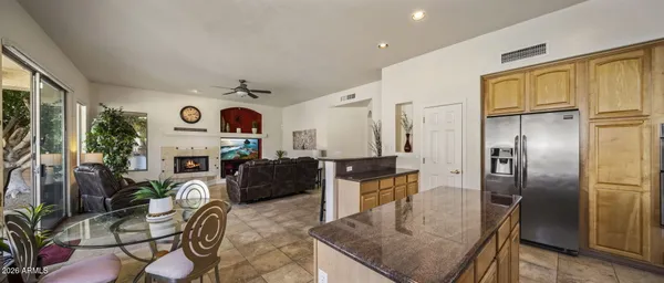 a living room with furniture a large window and a fireplace