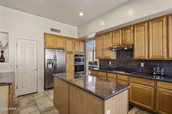 a kitchen with a sink and a stove top oven