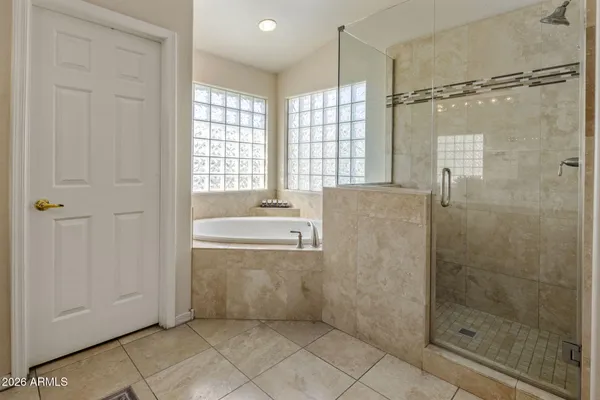 a bedroom with a bed dresser and a window