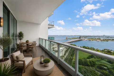 a balcony with wooden floor and furniture