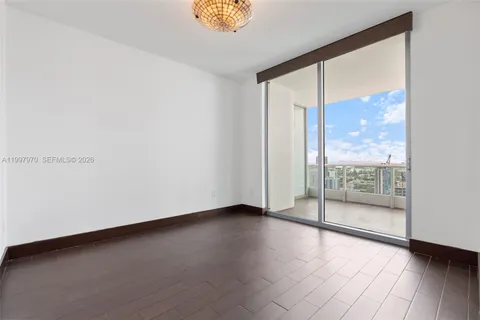 an empty room with wooden floor and a window