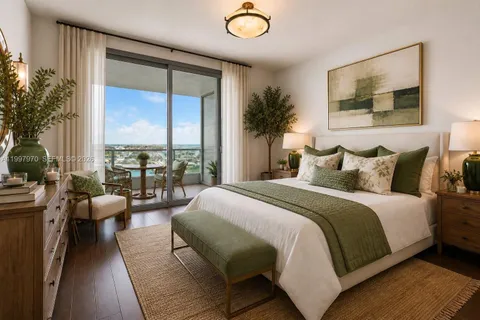 a bedroom with a large bed and a large window