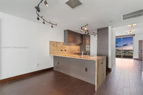an empty room with wooden floor and a window