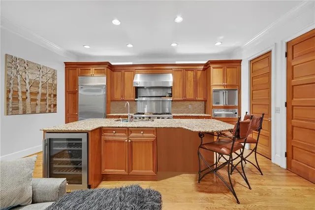 a kitchen with a stove a sink and a refrigerator